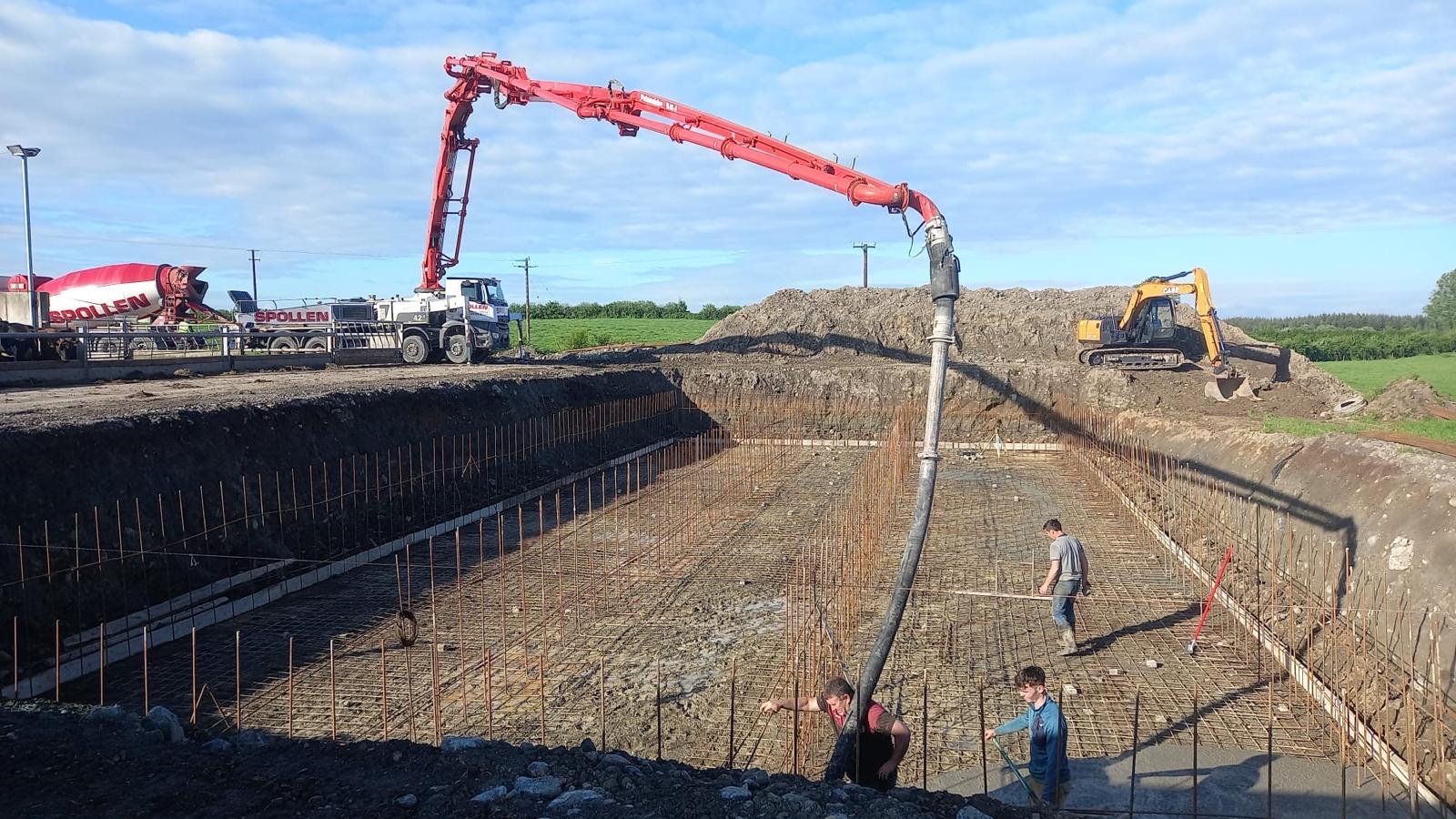 Pouring the reinforced base of a large slurry tank excavation