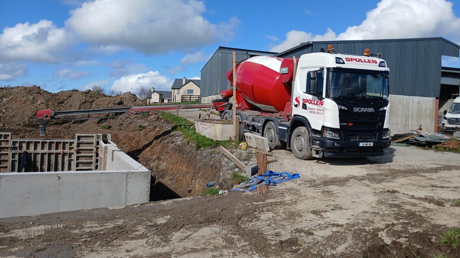 A Spollen mixer discharging at a farm yard tank pour