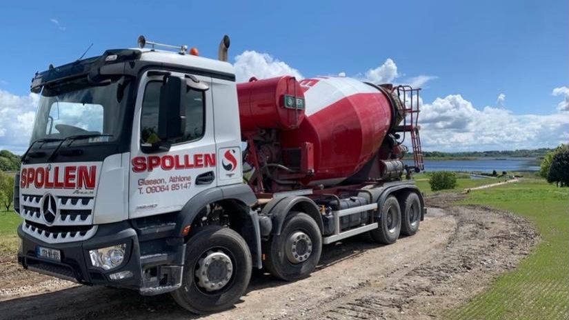 A Spollen mixer arriving on site along a farm track