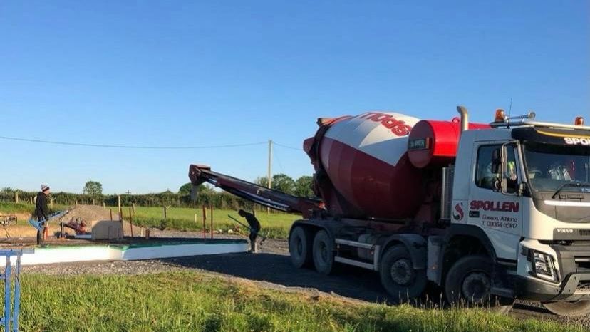 A Spollen mixer discharging down the chute on a rural site