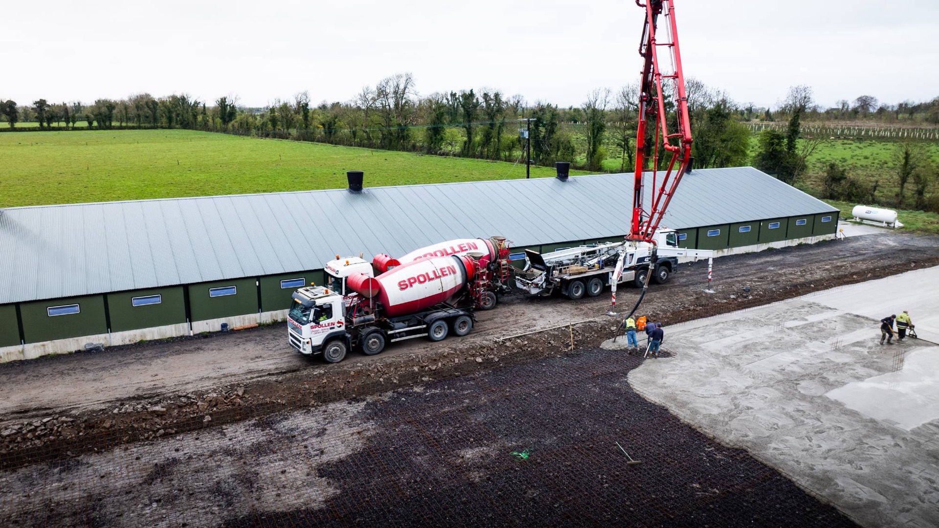 The 42m boom pump and a mixer working alongside a farm shed on a slab pour