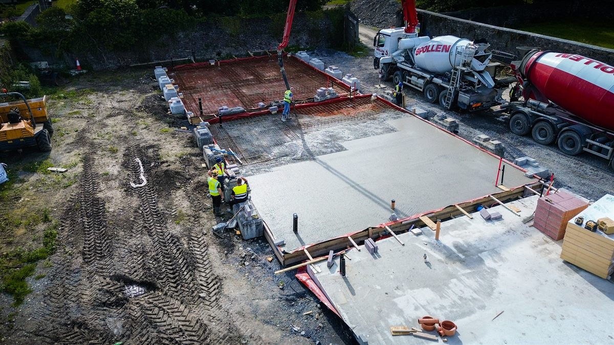 Aerial view of the slab pour with two mixers feeding the pump