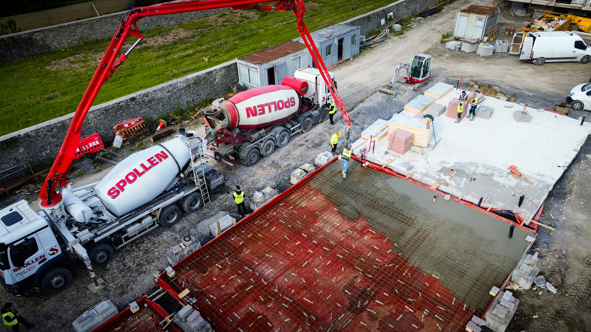 Spollen pump and mixers pouring a floor slab in a walled town-centre site