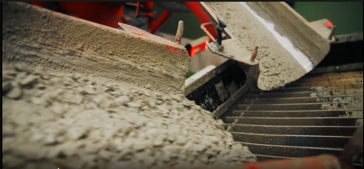 Fresh ready mix concrete discharging from the chutes of a Spollen mixer truck